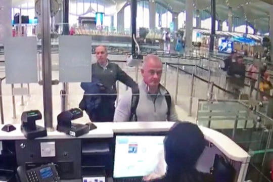 This Dec. 30, 2019 image from security camera video shows Michael L. Taylor, center, and George-Antoine Zayek at passport control at Istanbul Airport in Turkey. Taylor, a former Green Beret and his son, Peter Taylor, 27, were arrested Wednesday, May 20, 2020 in Massachusetts on charges they smuggled Nissan Motor Co. Chairman Carlos Ghosn out of Japan in a box in December 2019, while he awaited trial there on financial misconduct charges.