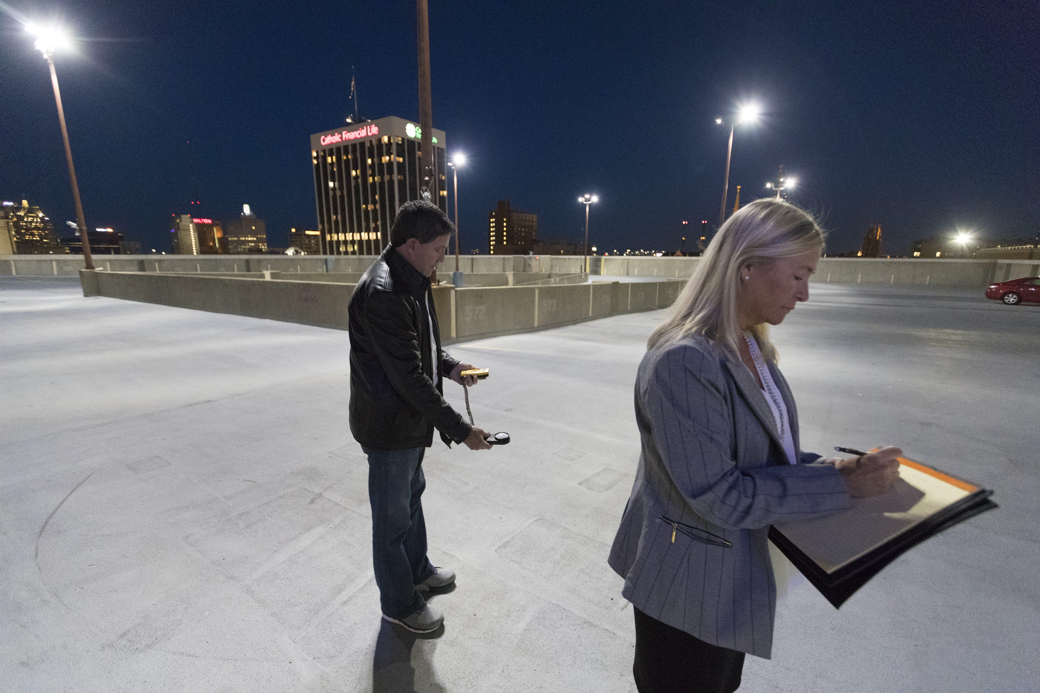 Architectural security consultant Randy Atlas, left, and paralegal-insurance adjuster Jamie Babcock record light level readings May 13, 2019, atop the parking garage at Aurora Sinai Medical Center in Milwaukee. The Journal Sentinel hired Atlas to evaluate security at garages at five Milwaukee hospitals.