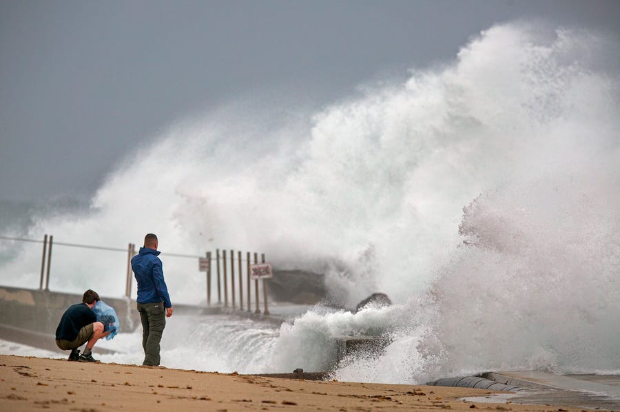 Waves driven by Tropical Storm Isaias crash over the jetty on the north side of the Palm Beach Inlet in Palm Beach Shores Sunday, Aug. 2, 2020. 