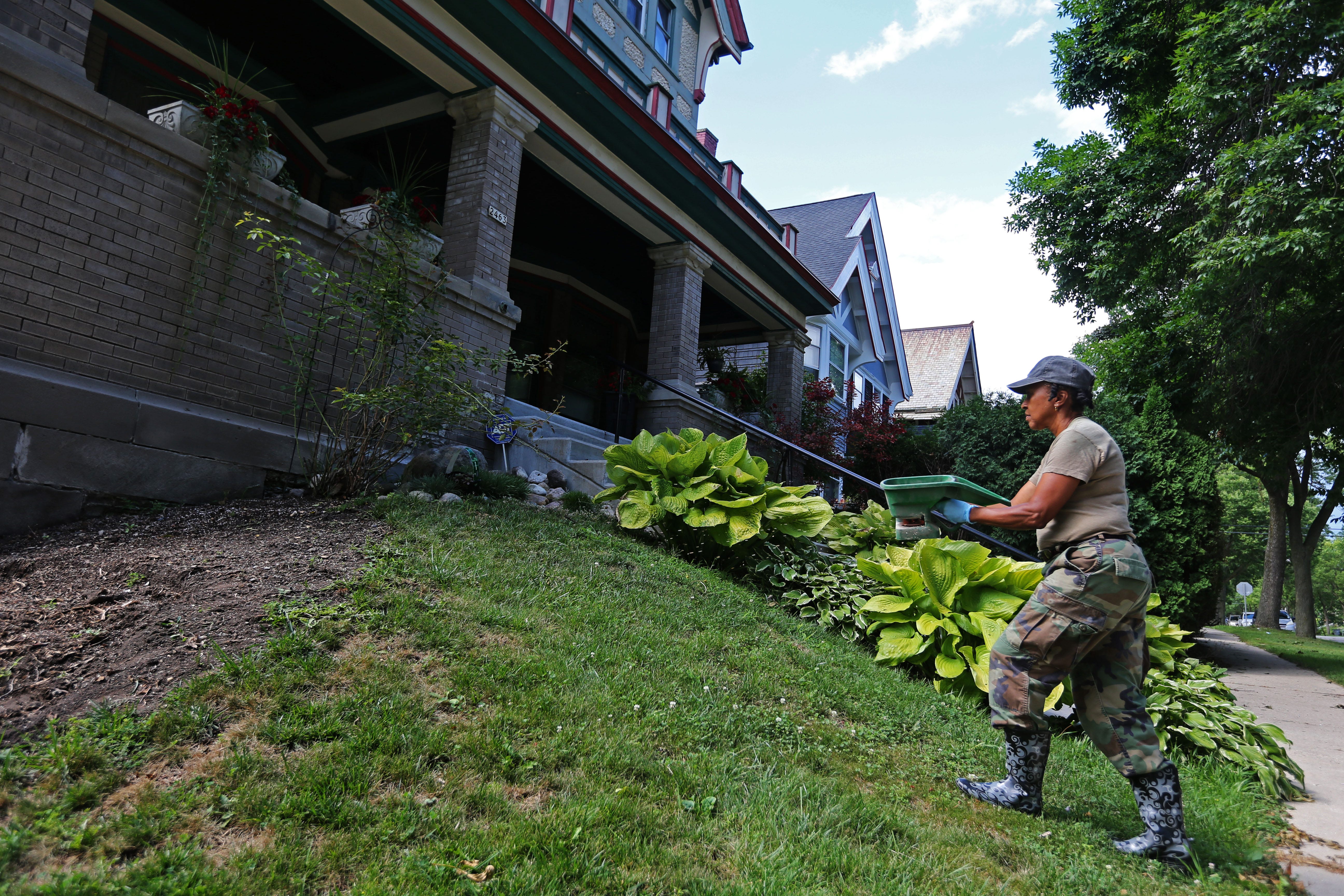 Homeowner and retired Army reservist registered nurse, Dorothy Greer applies fertilizer to her front yard. Greer and her husband Calvin bought the house on N. Palmer St. in 1997. Their first home was near N 28th and W Meinecke that they purchased through the $1 program from the City of Milwaukee which also gave them a $25,000 interest-free loan. Greer said their monthly mortgage was $110. “We were so proud to have something of our own. It’s something about owning your own home. It’s yours,” said Greer.