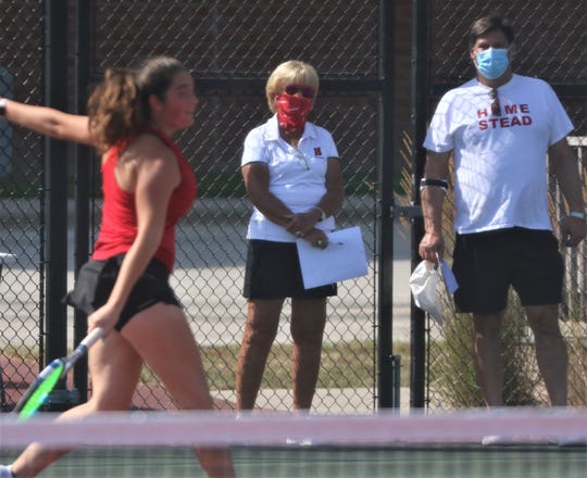 Head coach Jackie Egelhoff, center, looks on as the Homestead girls tennis team began its official practices on Monday, August 17.