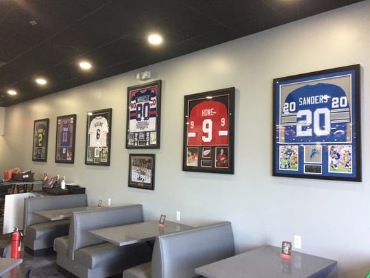 Jerseys autographed by notable Michigan athletes line a wall at Hatorando Sushi and Sports Bar, set to open next week in Hartland Township, Friday, Aug. 21, 2020.