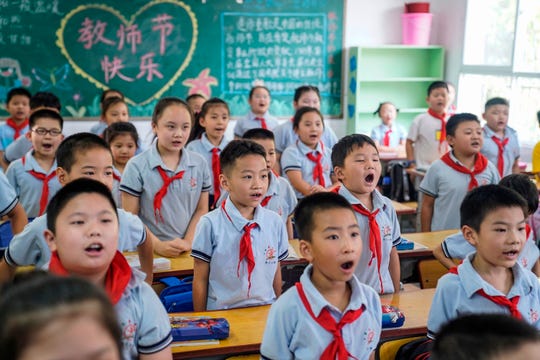 Elementary school students attend a class on the first day of the new semester in Wuhan in China's central Hubei province on September 1, 2020.