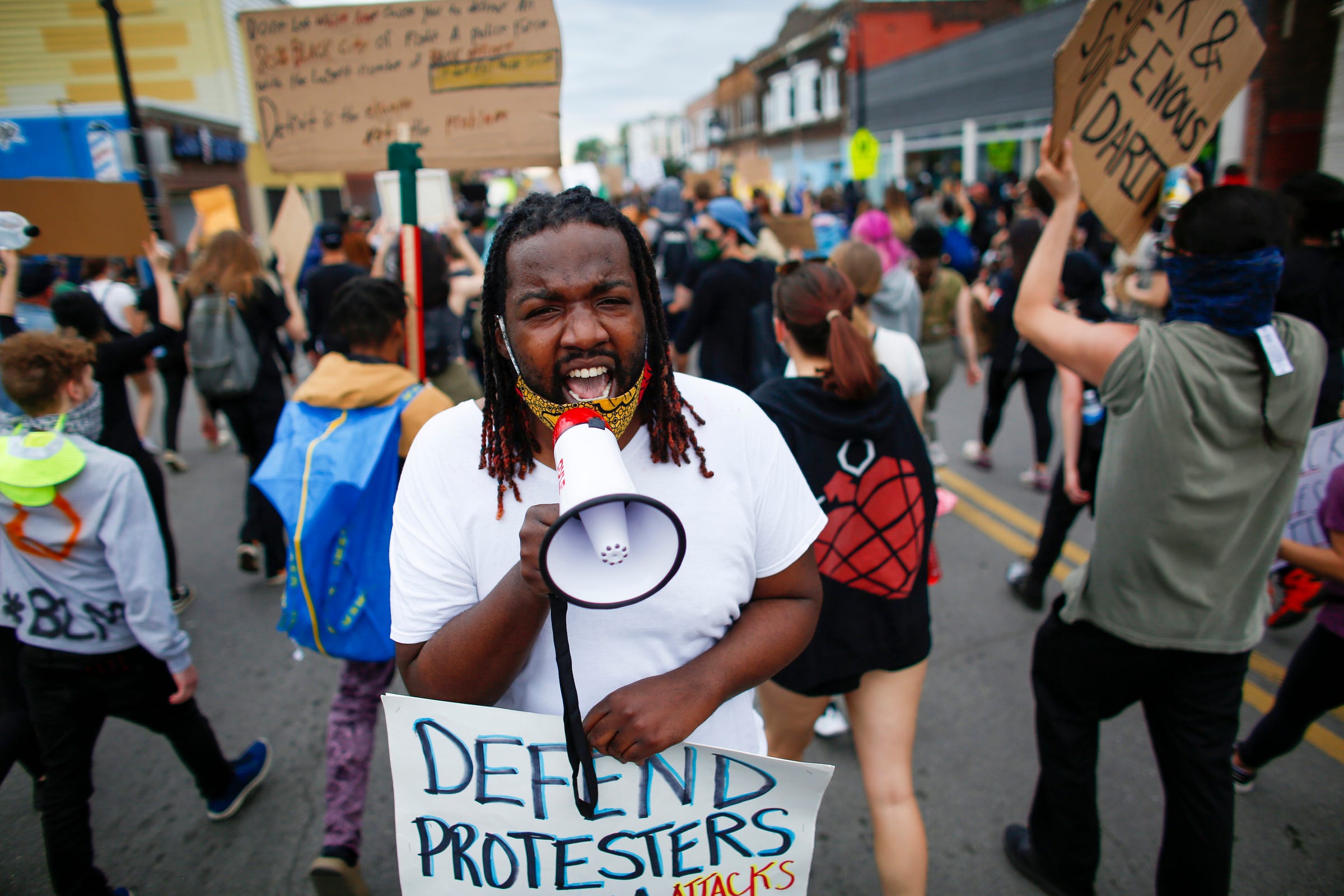 A demonstrator shouts the protest chant, "hands up, don't shoot," as he and other protesters march through southwest Detroit to protest police brutality and the death of George Floyd on Monday, June 1, 2020.