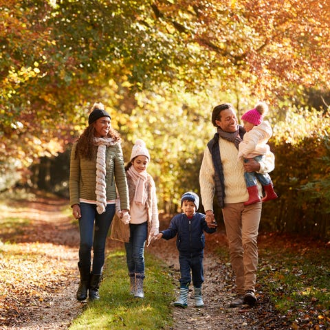 Front View Of Family Enjoying Autumn Walk In Count