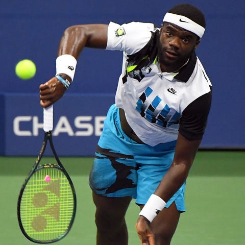 Frances Tiafo serves the ball against Danil Medved