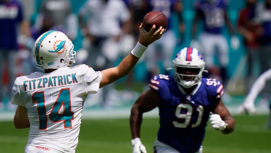 Miami Dolphins quarterback Ryan Fitzpatrick (14) looks to pass as Buffalo Bills defensive tackle Ed Oliver (91) is down field, during the first half of an NFL football game, Sunday, Sept. 20, 2020 in Miami Gardens, Fla.