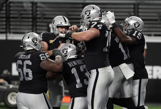 Las Vegas Raiders players celebrate a touchdown by wide receiver Zay Jones against the New Orleans Saints during the second quarter of a NFL game at Allegiant Stadium.