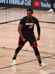 Miami Heat forward Bam Adebayo flexes after dunking during Game 6 against the Boston Celtics.