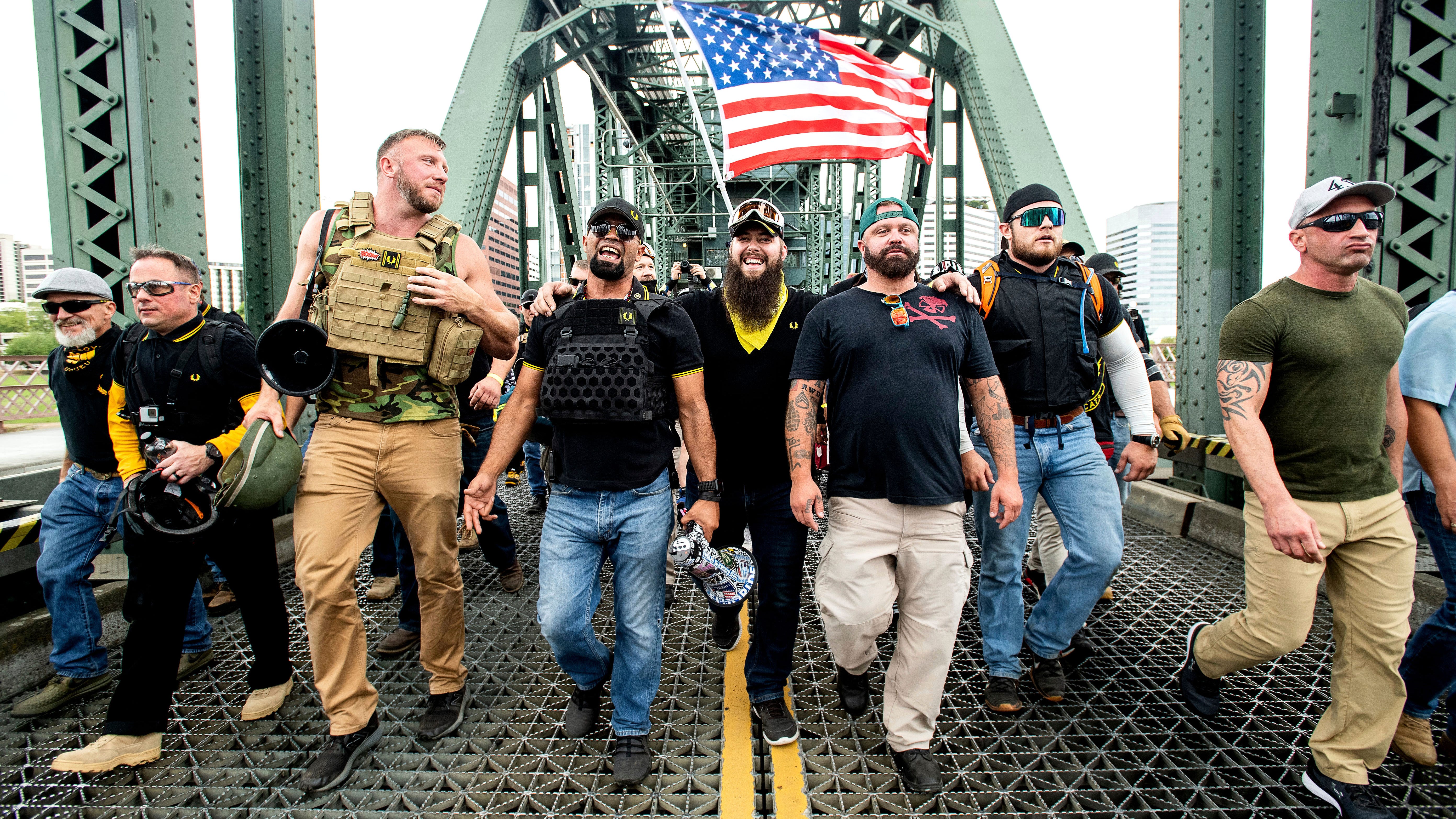 Members of the Proud Boys, including Joe Biggs of Ormond Beach, third from right, and other right-wing demonstrators march across the Steel Bridge on Aug. 17, 2019, in Portland, Oregon. Biggs had organized an "End Domestic Terrorism" rally there as an anti-Antifa rally.