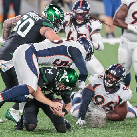 New York Jets quarterback Sam Darnold (14) is sack