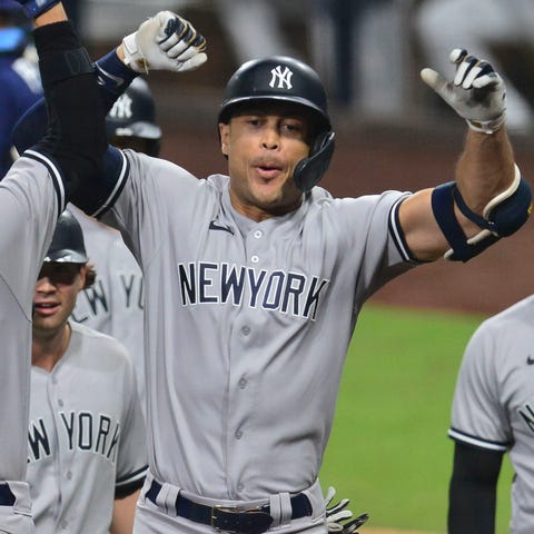 Giancarlo Stanton is congratulated by Gio Urshela 