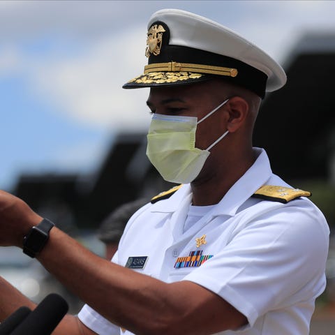 U.S. Surgeon General Jerome Adams demonstrates the