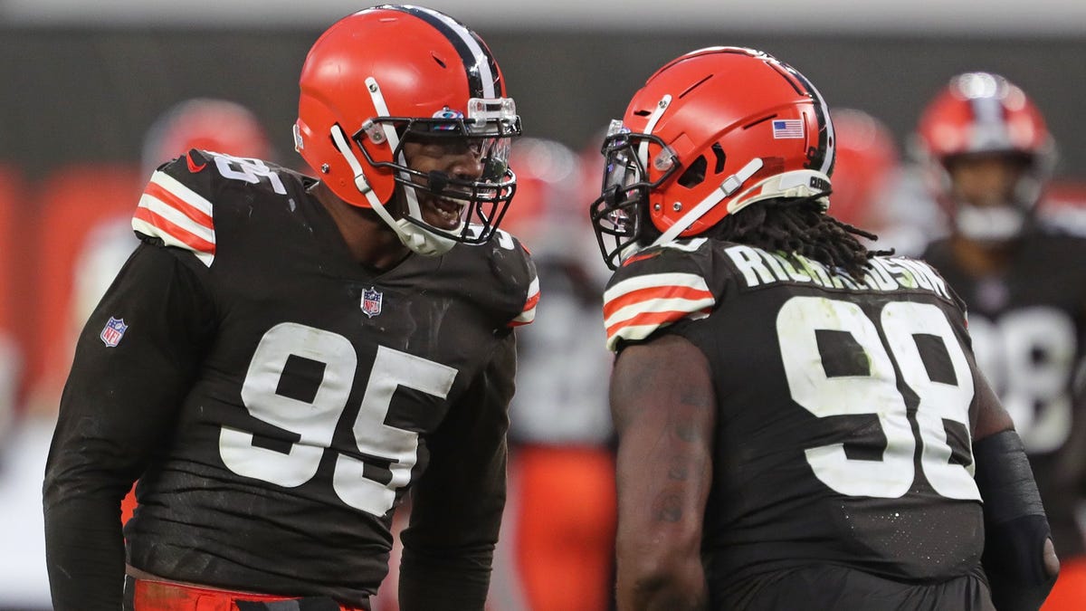 Cleveland Browns safety Sheldrick Redwine, left, celebrates with teammates  after an interception during the second half of an NFL football game  against the Indianapolis Colts, Sunday, Oct. 11, 2020, in Cleveland. The