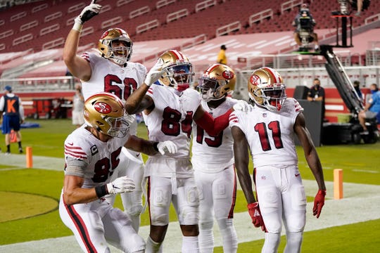 Teammates celebrate with Brandon Aiyuk #11 of the San Francisco 49ers after Aiyuk scored a touchdown against the Los Angeles Rams during the second quarter at Levi's Stadium on October 18, 2020 in Santa Clara, California.