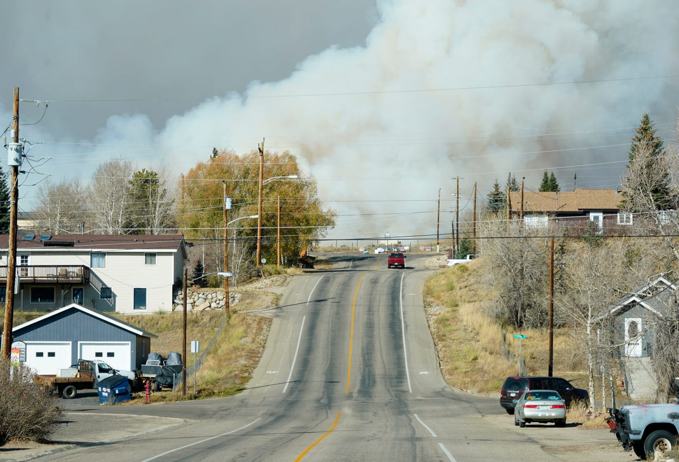 Colorado wildfires Photos show orange skies, towering smoke