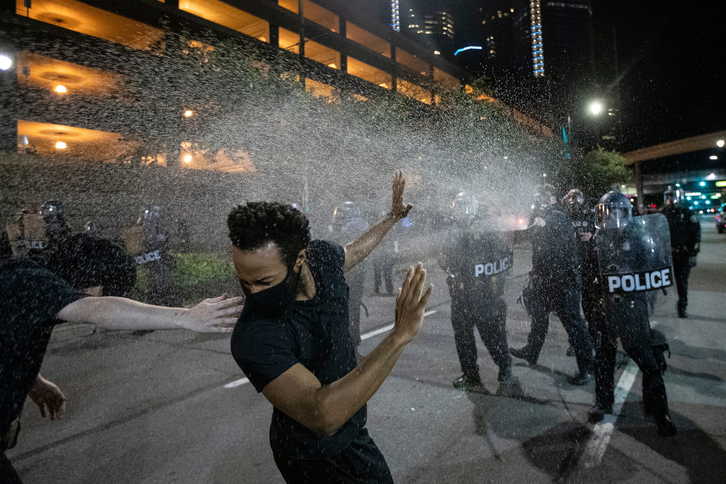 Protesters are being sprayed by Detroit Police officers in riot gear in downtown Detroit, Friday, May 29, 2020.
