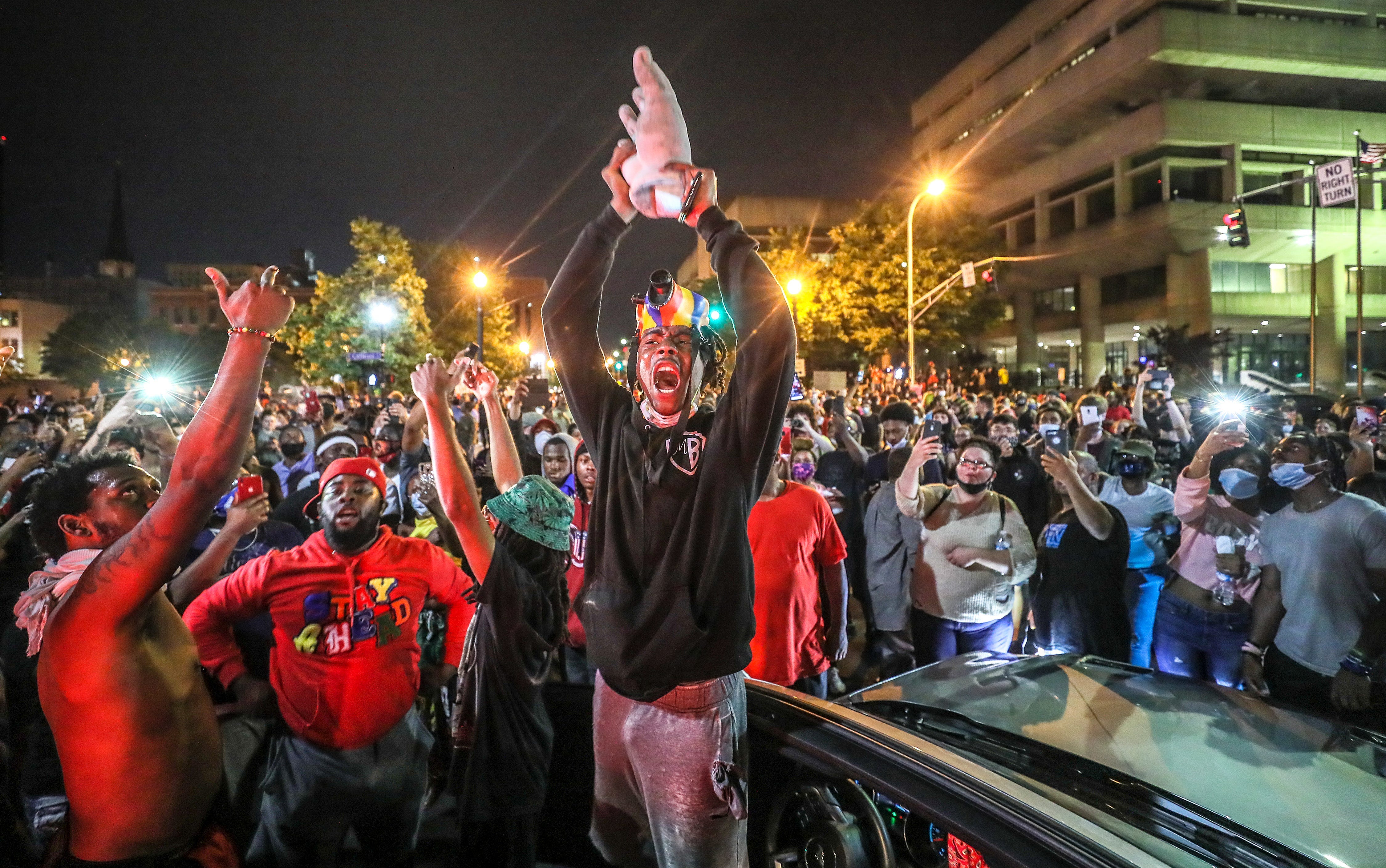 A protester holds up the hand of King Louis XVI after it was torn from the statue during a demonstration on Thursday, May 28, 2020. Louisville broke into protests following the murder of Breonna Taylor.