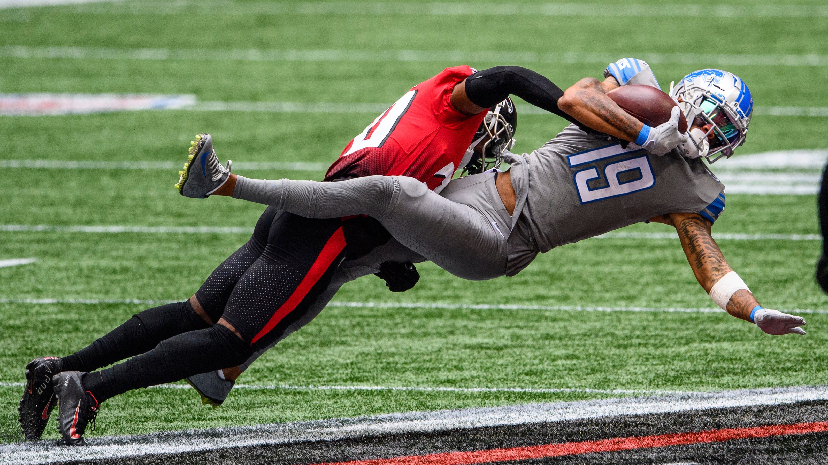 Detroit Lions wide receiver Kenny Golladay is tackled by Atlanta Falcons defensive back Kendall Sheffield.