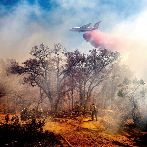 An air tanker drops retardant on the Olinda Fire b