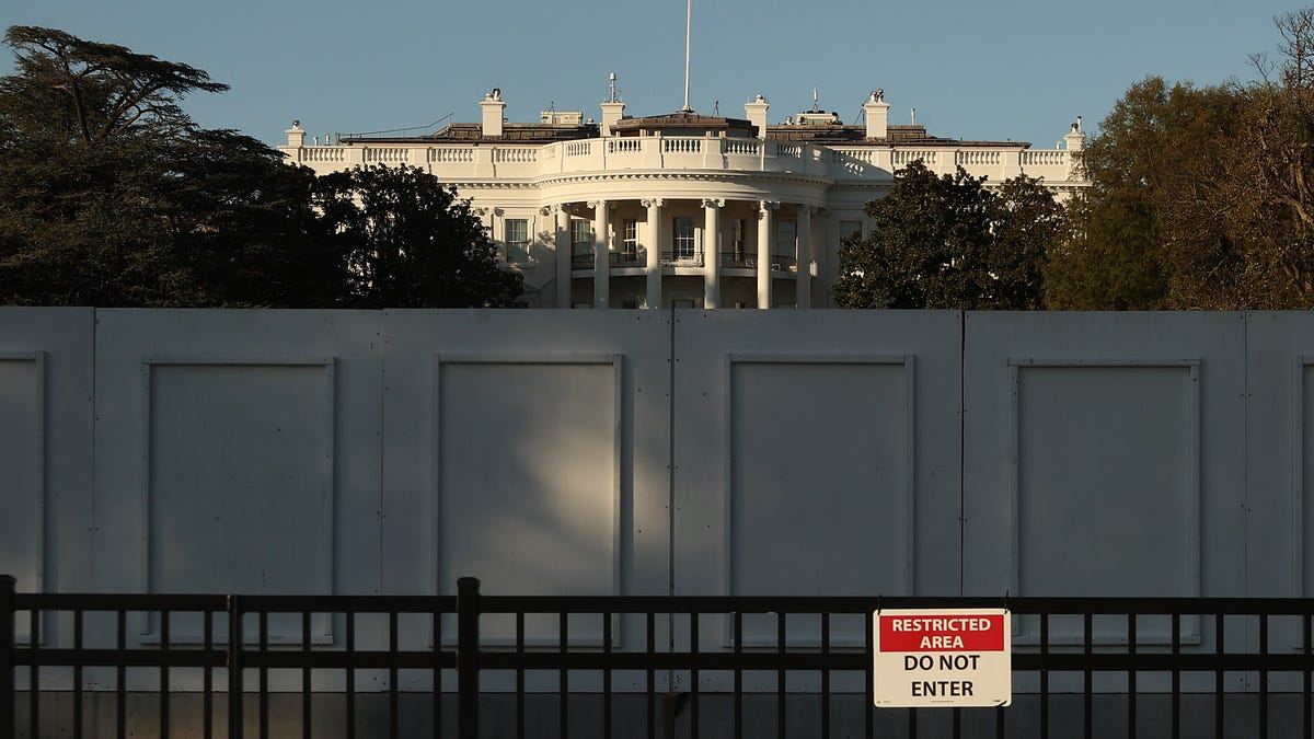 The south side of the White House is seen behind layers of fencing less than 24 hours before Election Day on Nov. 2, 2020, in Washington, D.C. Extra layers of fencing have been in place for several months around the White House after the violence that followed George Floyd's death while in Minneapolis police custody earlier this year.