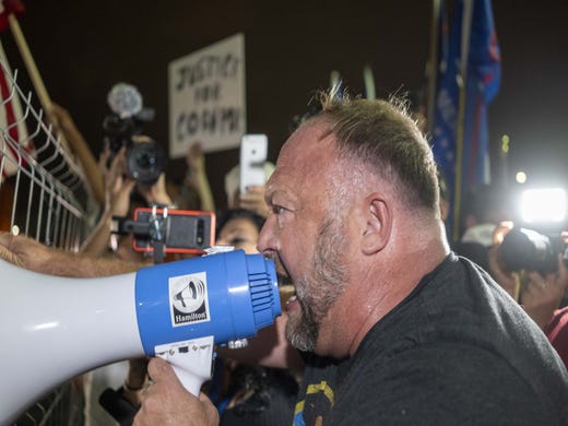 Alex Jones yells into a megaphone at a protest outside the Maricopa County Tabulation and Election Center in downtown Phoenix on Nov. 6, 2020.