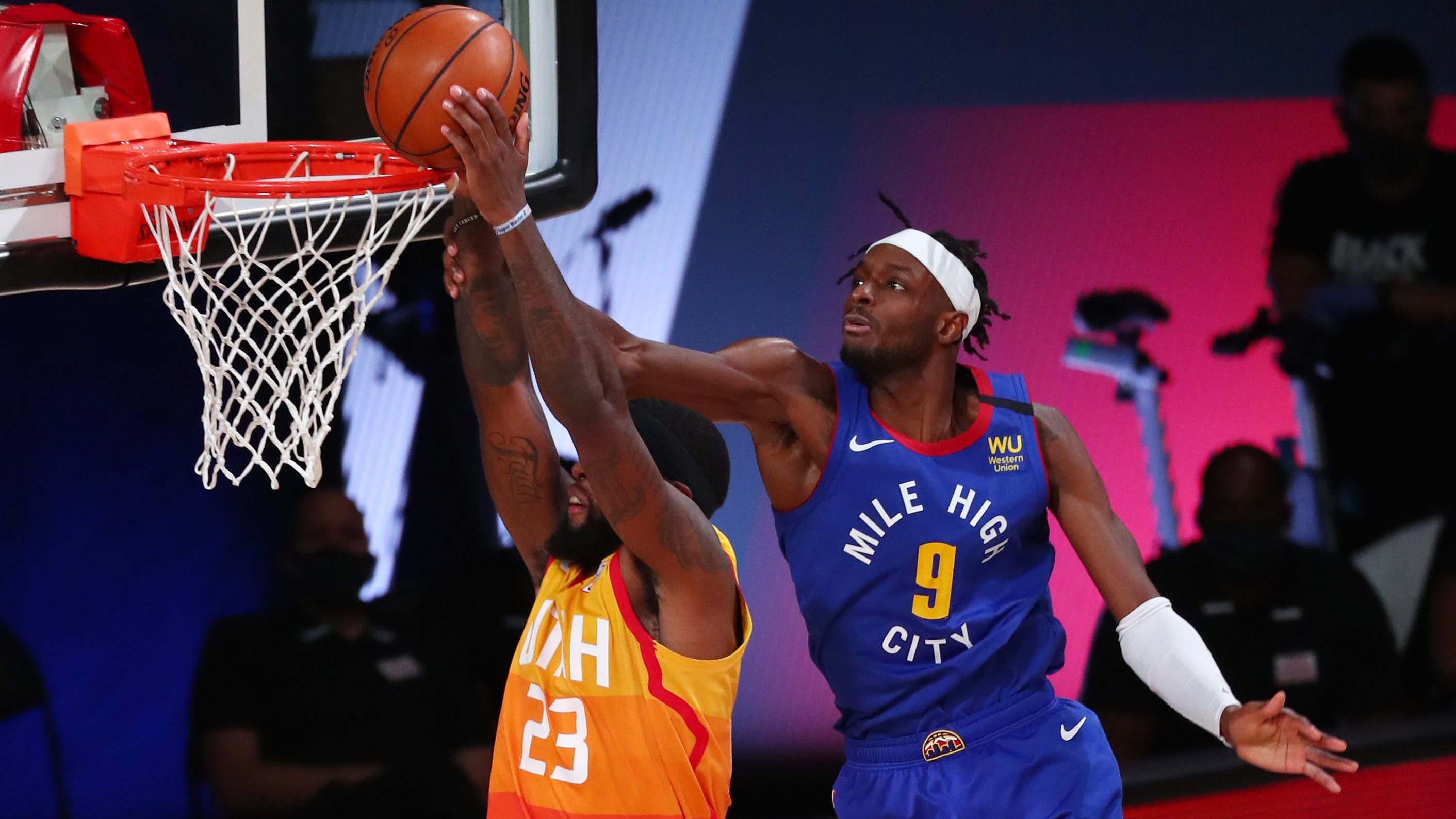 Denver Nuggets forward Jerami Grant fouls Utah Jazz forward Royce O'Neale during Game 6 of the first round of the playoffs, Aug. 30, 2020 in Lake Buena Vista, Fla.