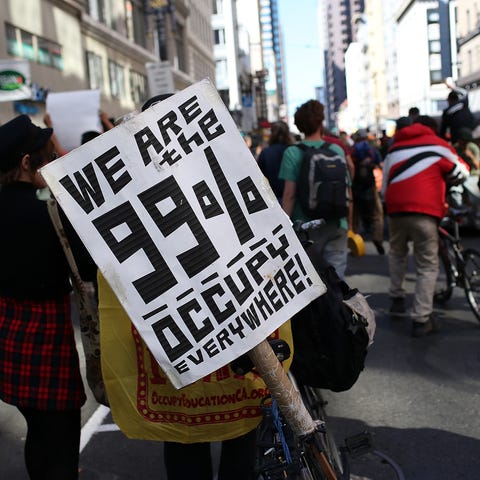 An Occupy Wall Street protester holds a sign durin