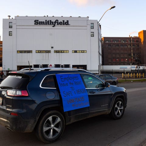 A car sporting a sign calling for a safe and healt