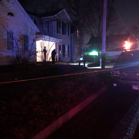 Peoria police look for evidence outside a house in