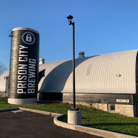 A former grain silo is adorned with Prison City Br