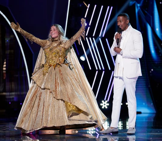 LeAnn Rimes (with host Nick Cannon) was revealed as the winner Season 4 of "The Masked Singer," but with no studio audience, Fox faked it with old footage.