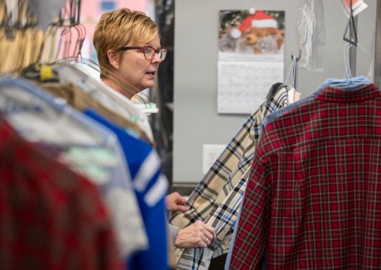 Beth Miller looks over orders at Bolden's Dry Cleaners in downtown Noblesville, Wednesday, Dec. 30, 2020. The city has provided grants to help keep businesses afloat. 