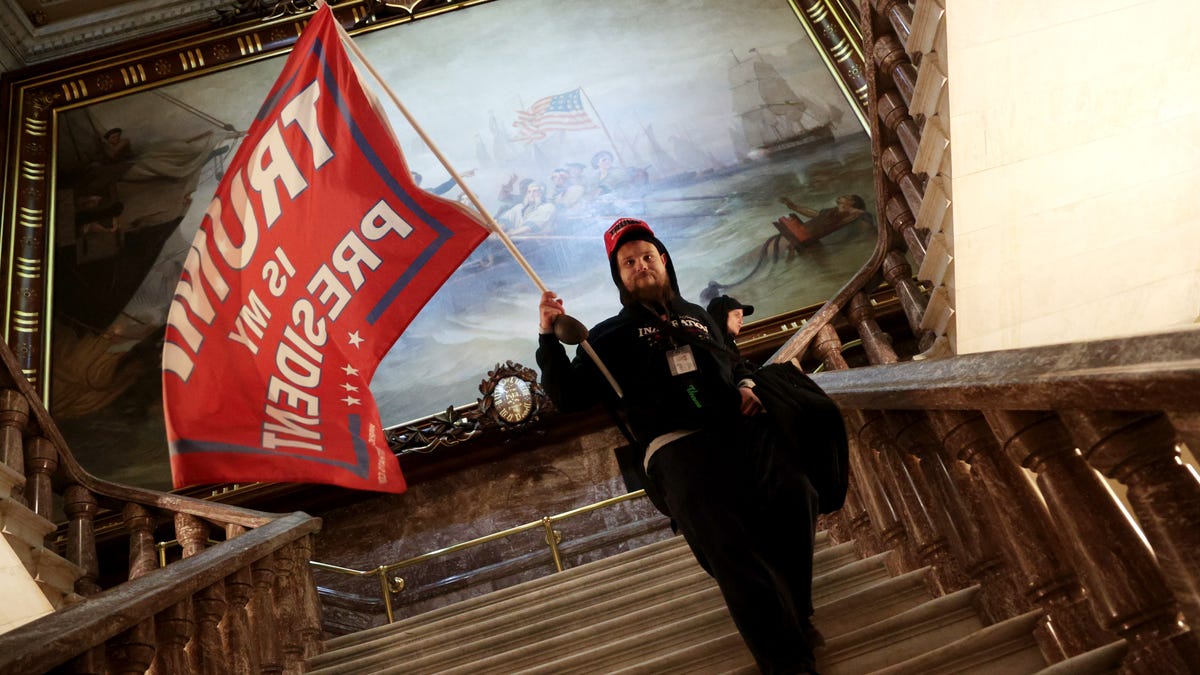 A protester holds a Trump flag inside the US Capitol Building near the Senate Chamber on January 6, 2021 in Washington, DC.