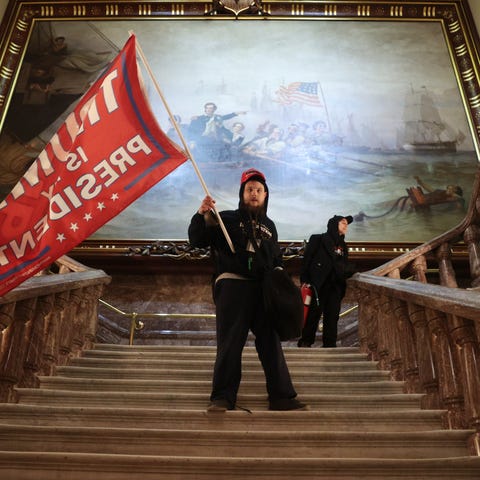 A protester holds a Trump flag inside the US Capit