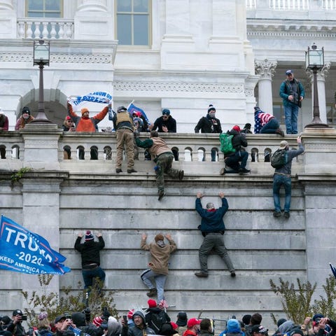 Pro-Trump rioters climb the west wall of the U.S. 