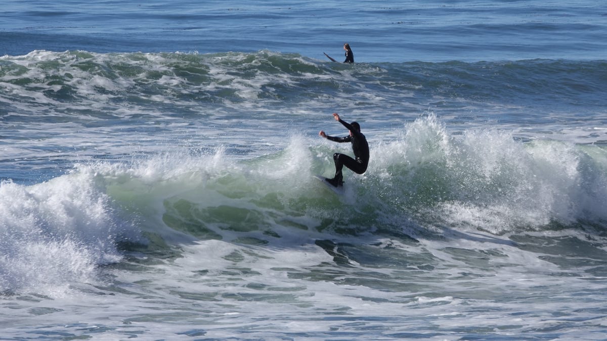 Surfers enjoyed waves on a hot weekend near Mondos Beach off Pacific Coast Highway on Jan. 17, 2021.