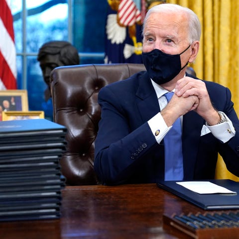 President Joe Biden waits to sign his first execut