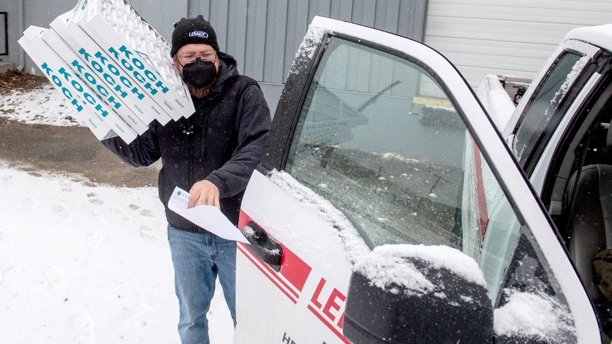 Thomas Crutcher, a driver for Fritch Heating & Cooling, 1004 NE Adams St., loads up a set of furnace filters for delivery Tuesday, Jan. 26, 2021 from the T.F. Ehrhart HVAC wholesale supplier in Peoria. HVAC worker and other service technicians like plumbers and electricians are considered essential workers under COVID-19 mitigation rules, but don’t qualify for Phase 1B vaccinations. 