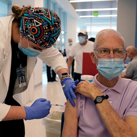 Dean Coleman, right, receives the Pfizer-BioNTech 