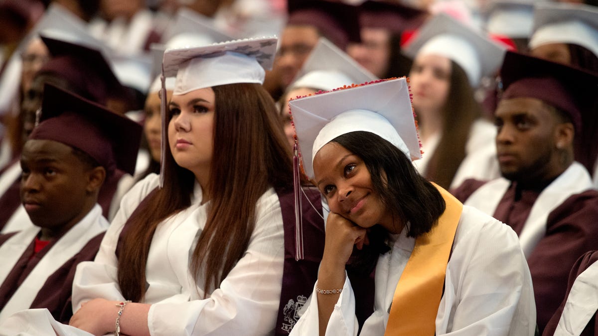 Peoria High School graduates watch a slideshow of photos of their senior year presented during the senior address by valedictorian Olivia Streeter on Saturday, May 18, 2019 at Renaissance Coliseum.