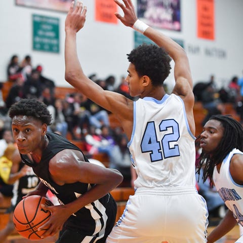 Emaryon Byrd drives to the hoop during a boys bask