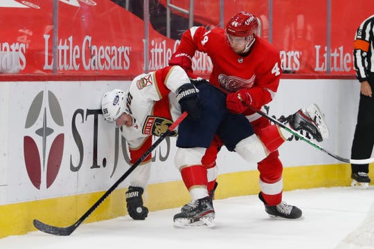 Florida Panthers center Noel Acciari controls the puck against Detroit Red Wings defenseman Christian Djoos during the first period at Little Caesars Arena on Sunday, Jan. 31, 2021.