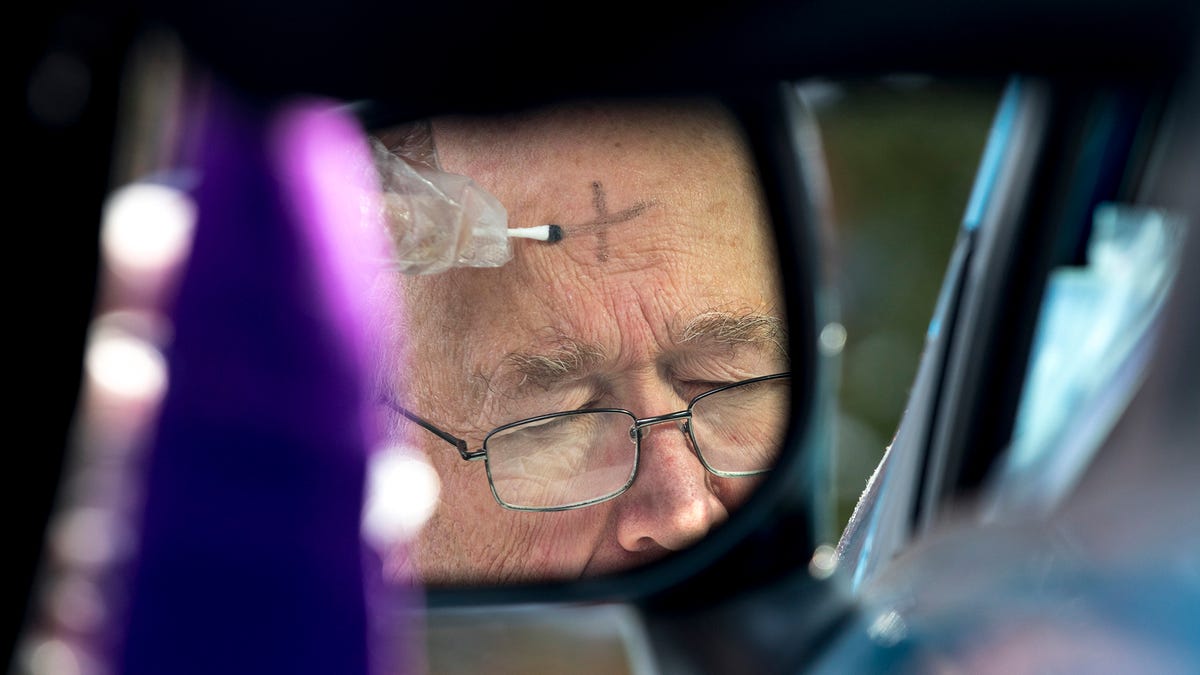 A parishioner receives ashes during a drive-thru service in Finneytown, Ohio, in February 2021.