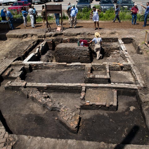 Scott Hewitt stands in what was the cellar of a ho