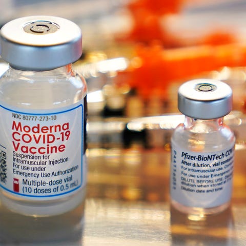 Bottles of the Moderna and Pfizer COVID-19 vaccine