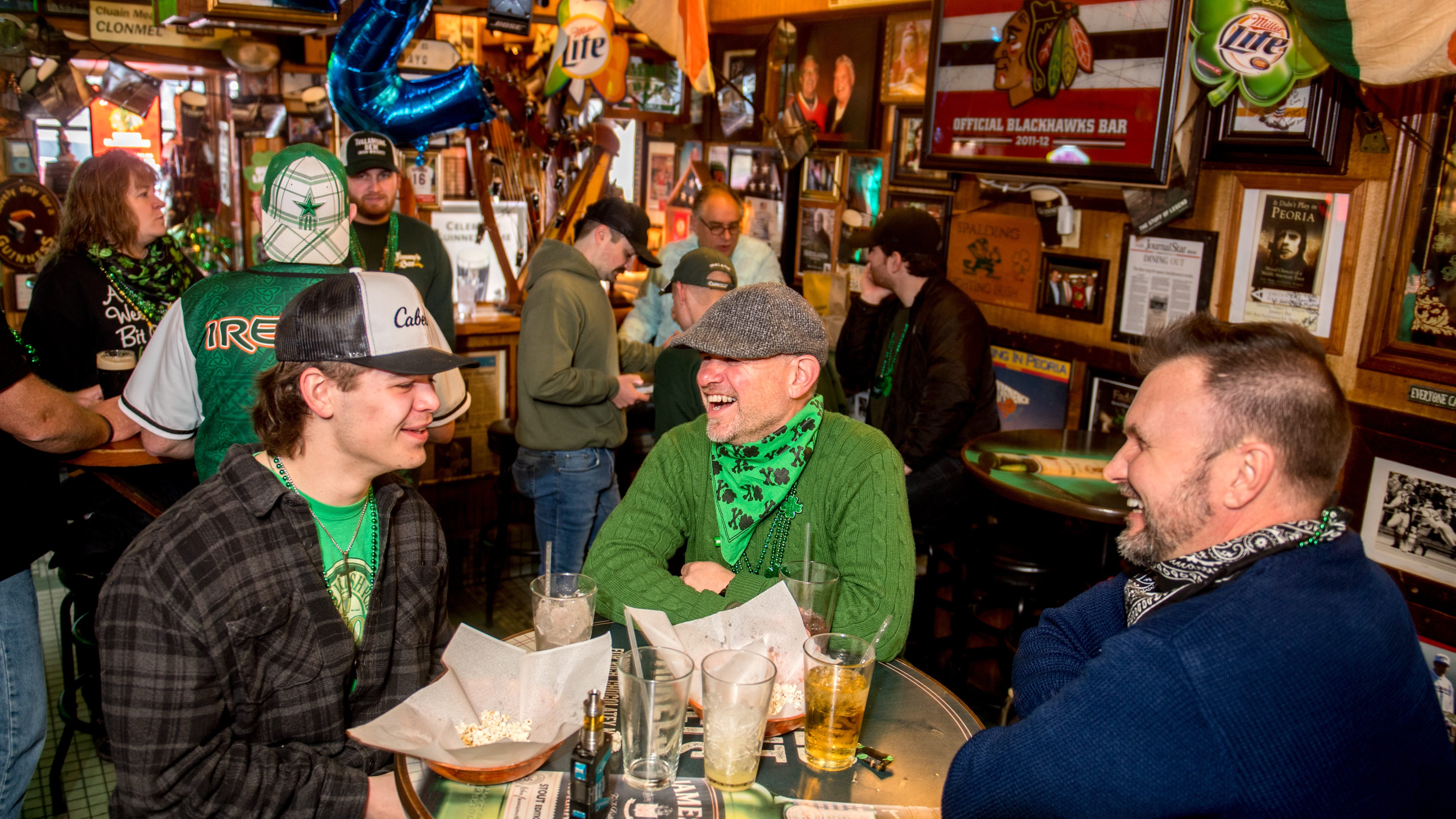 Riley Driscoll, left, his dad Donnie Driscoll, middle, both of West Peoria and Edward Watkins of East Peoria joined their friend Tom Matheny early Wednesday, March 17, 2021 for a few St. Patrick’s Day laughs and libations at Jimmy’s Bar in West Peoria. Riley Driscoll was celebrating his first St. Patrick’s Day as a 21-year-old.