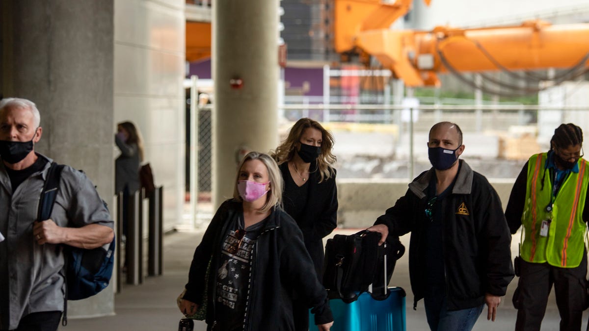 Travelers enter a parking garage at Nashville International Airport on Thursday, March 18, 2021 in Nashville, Tenn. The airport is busier now with travelers than at any time since the COVID outbreak.