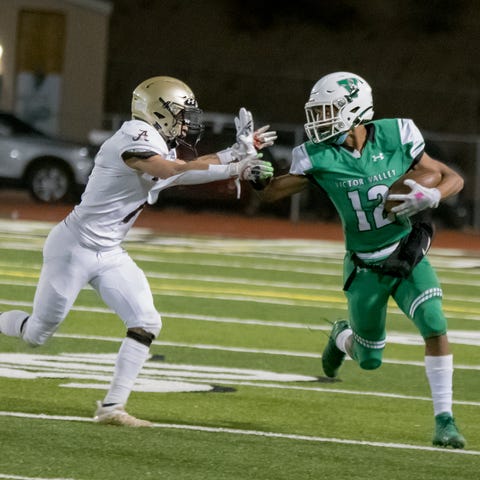 Victor Valley's Corinthians Jones, right, runs upf