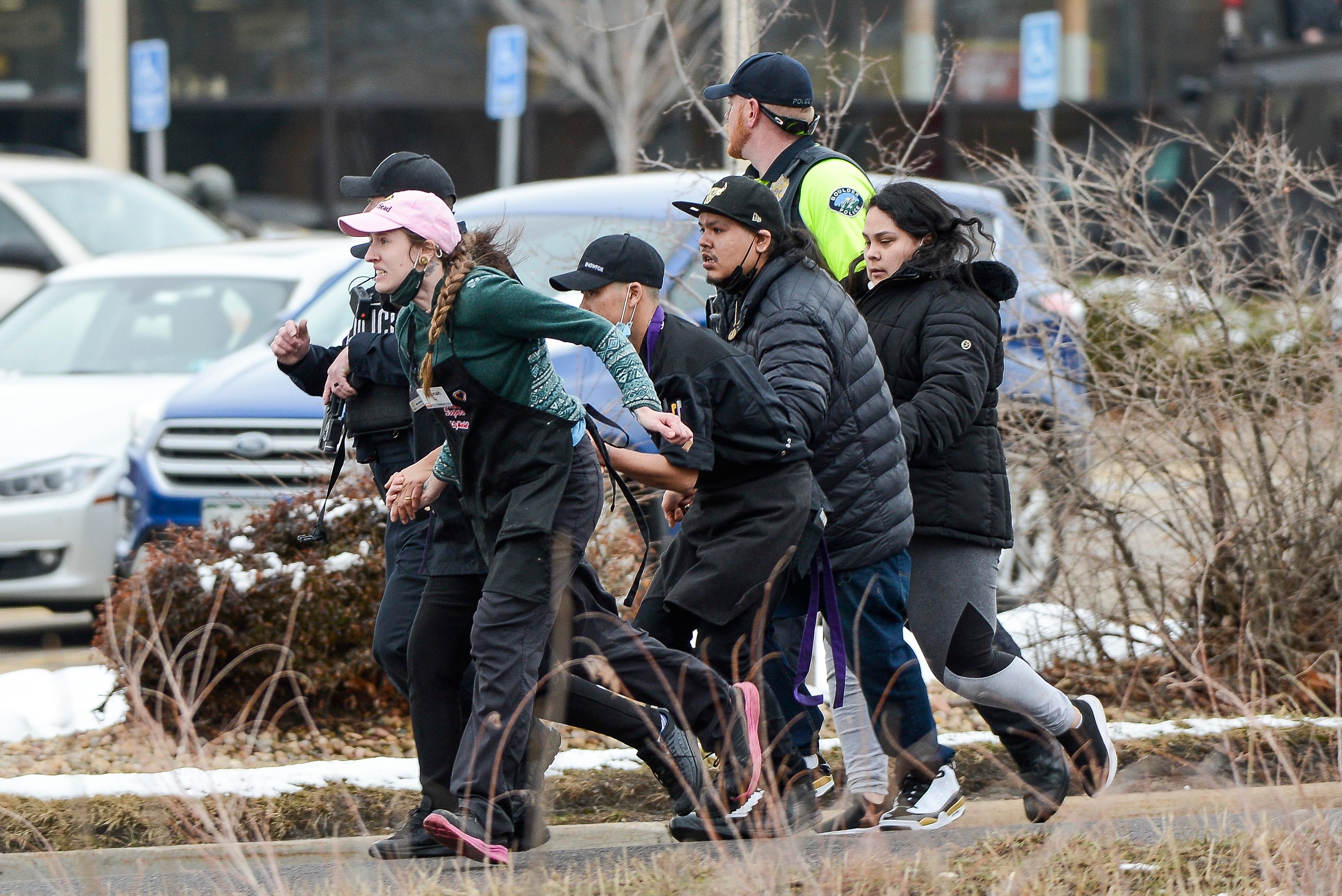King Soopers employees are led away from an active shooter at the King Soopers grocery store in Boulder Colo. on March 22. 2021.